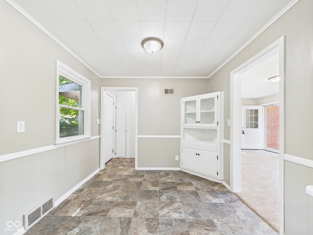 220 Central Ave, Anderson, IN 46012 - unfurnished dining area with ornamental molding, stone finish floors, and baseboards