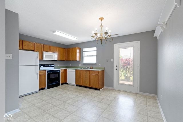 3423 Summer Breeze Cir, Indianapolis, IN 46239 - kitchen featuring white appliances, a chandelier, light countertops, brown cabinetry, and pendant lighting