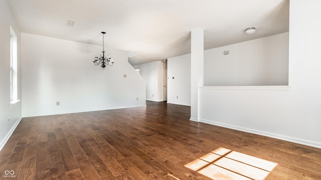 10216 Hatherley Way, Fishers, IN 46037 - unfurnished room featuring a chandelier and dark wood-style flooring