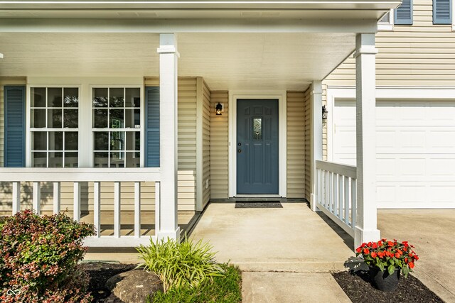 10216 Hatherley Way, Fishers, IN 46037 - property entrance featuring covered porch and an attached garage