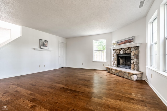 10216 Hatherley Way, Fishers, IN 46037 - unfurnished living room with a textured ceiling, wood-type flooring, and a fireplace