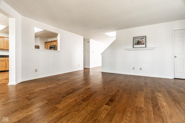 10216 Hatherley Way, Fishers, IN 46037 - unfurnished living room with dark wood-style floors and a textured ceiling