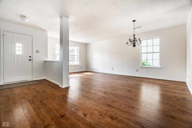 10216 Hatherley Way, Fishers, IN 46037 - foyer entrance featuring dark wood-style floors, a chandelier, and a textured ceiling