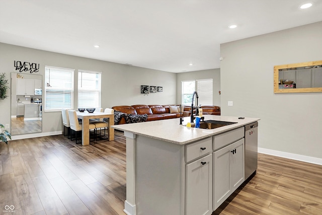 741 Scarsdale Ln, Danville, IN 46122 - kitchen featuring stainless steel dishwasher, light wood-style flooring, recessed lighting, an island with sink, and open floor plan