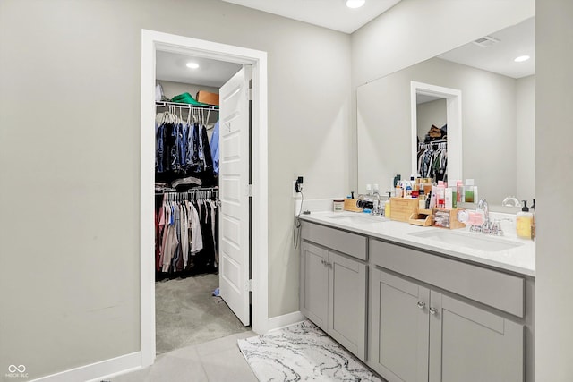 741 Scarsdale Ln, Danville, IN 46122 - bathroom with double vanity, a walk in closet, and recessed lighting