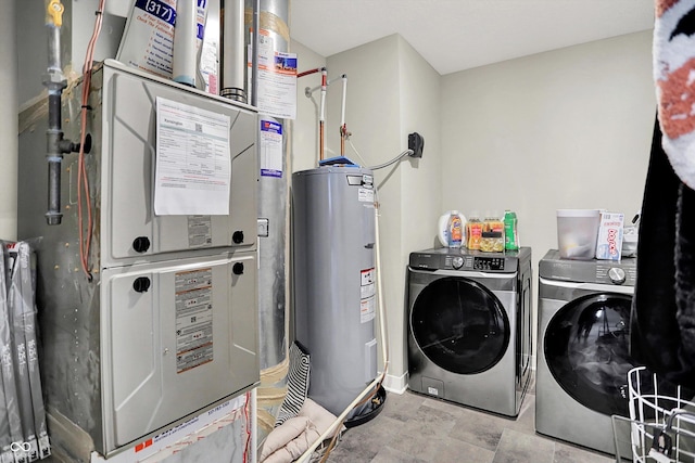 741 Scarsdale Ln, Danville, IN 46122 - laundry area with electric water heater, washer and clothes dryer, heating unit, and stone finish flooring