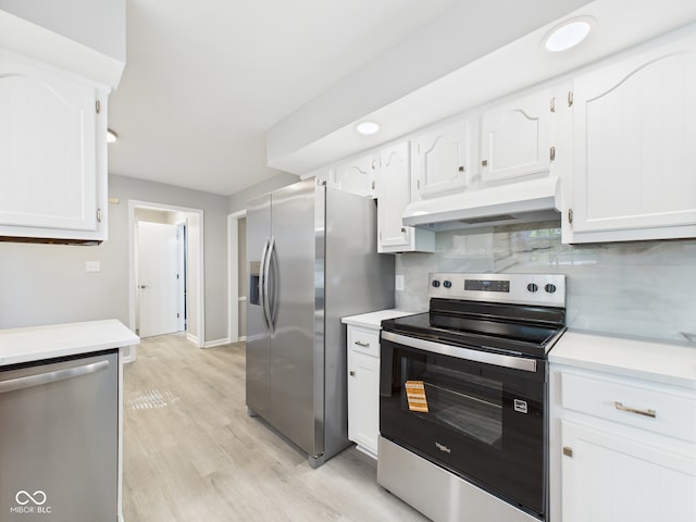 2126 Tartan Rd, Anderson, IN 46012 - kitchen featuring appliances with stainless steel finishes, range hood, light countertops, and white cabinets