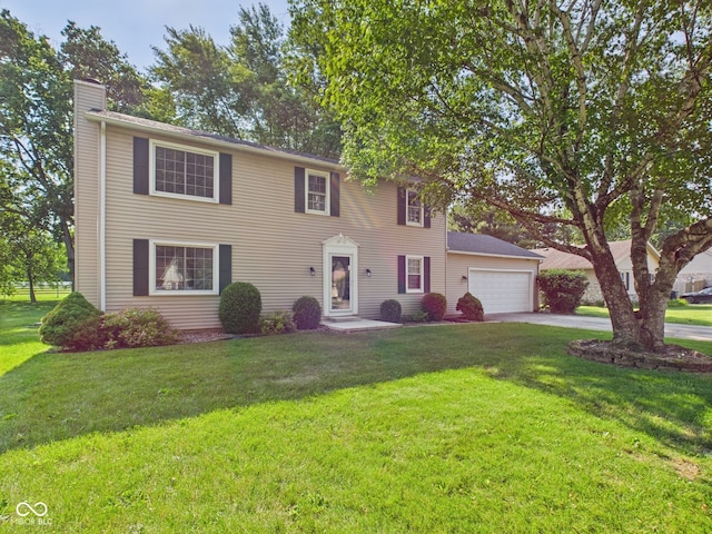 2126 Tartan Rd, Anderson, IN 46012 - colonial-style house with a chimney, driveway, a garage, and a front yard