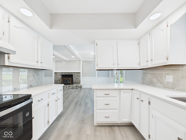 2126 Tartan Rd, Anderson, IN 46012 - kitchen featuring white cabinetry, stainless steel range with electric cooktop, light wood-type flooring, tasteful backsplash, and recessed lighting