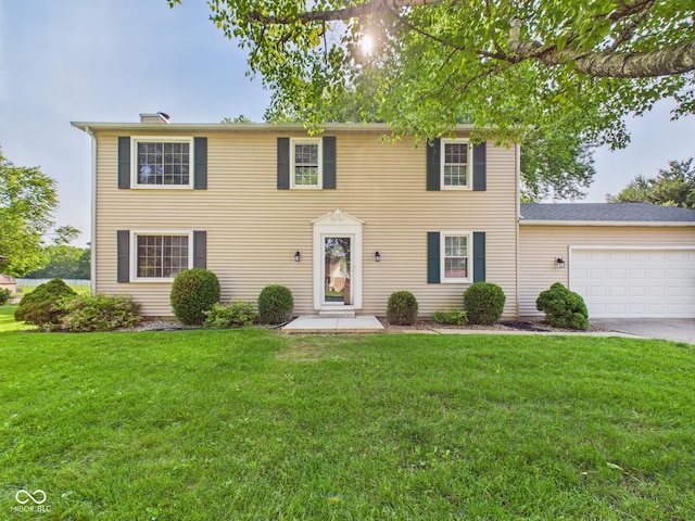 2126 Tartan Rd, Anderson, IN 46012 - colonial inspired home featuring an attached garage, a front lawn, and concrete driveway