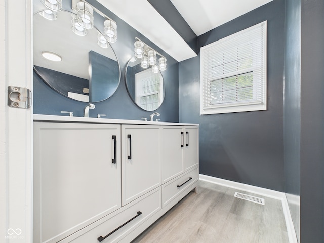 2126 Tartan Rd, Anderson, IN 46012 - bathroom featuring wood finished floors and double vanity