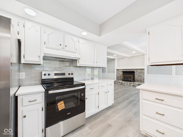 2126 Tartan Rd, Anderson, IN 46012 - kitchen with stainless steel range with electric stovetop, custom exhaust hood, light countertops, white cabinetry, and recessed lighting