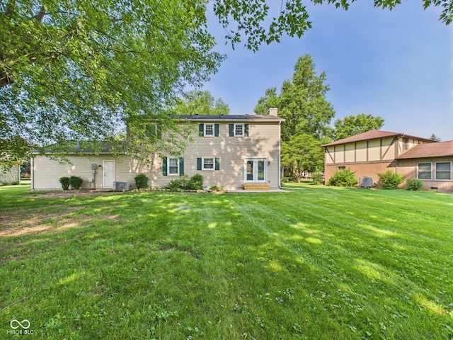 2126 Tartan Rd, Anderson, IN 46012 - rear view of property with a lawn and a chimney