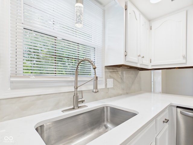 2126 Tartan Rd, Anderson, IN 46012 - kitchen with white cabinetry, backsplash, light countertops, and dishwasher