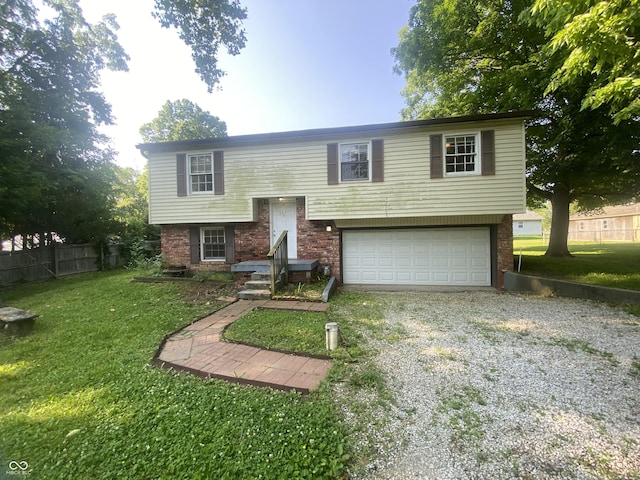 667 E Edgewood Ave, Indianapolis, IN 46227 - split foyer home featuring a garage, driveway, and brick siding