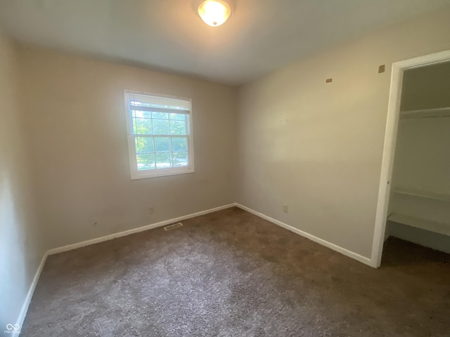 667 E Edgewood Ave, Indianapolis, IN 46227 - unfurnished bedroom featuring carpet flooring, a closet, and a walk in closet