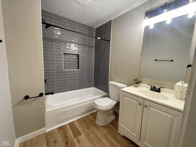 3835 N Kenwood Ave, Indianapolis, IN 46208 - bathroom with a textured ceiling, wood finished floors, vanity, shower / washtub combination, and toilet