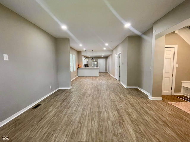 3835 N Kenwood Ave, Indianapolis, IN 46208 - unfurnished living room with dark wood finished floors, baseboards, and recessed lighting