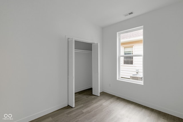 1409 N Grant Ave, Indianapolis, IN 46201 - unfurnished bedroom featuring wood finished floors and a closet