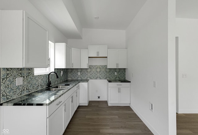 1409 N Grant Ave, Indianapolis, IN 46201 - kitchen with white cabinets, decorative backsplash, dark wood finished floors, and dark stone counters