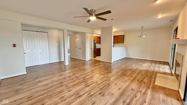 8176 Shorewalk Dr Unit C, Indianapolis, IN 46236 - unfurnished living room with a ceiling fan, light wood finished floors, and a fireplace with flush hearth