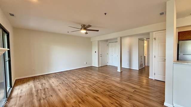 8176 Shorewalk Dr Unit C, Indianapolis, IN 46236 - unfurnished bedroom with freestanding refrigerator, wood finished floors, and ceiling fan