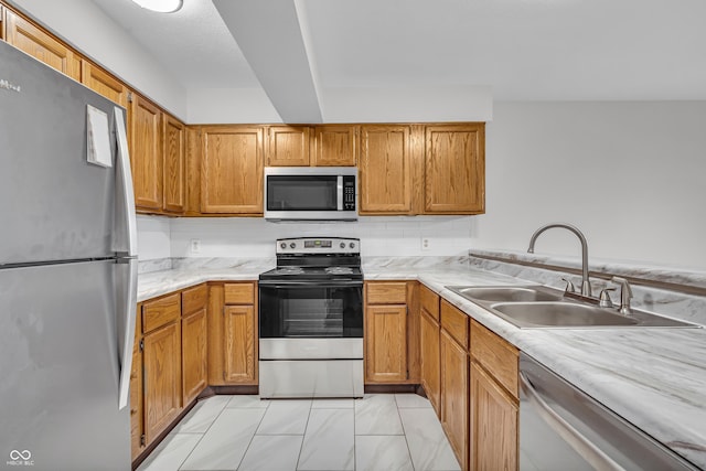 8176 Shorewalk Dr Unit C, Indianapolis, IN 46236 - kitchen with appliances with stainless steel finishes, light countertops, and brown cabinetry