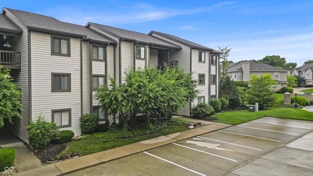 8176 Shorewalk Dr Unit C, Indianapolis, IN 46236 - view of building exterior featuring uncovered parking and a residential view