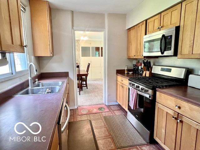 1802 Laurel Dr, Columbus, IN 47203 - kitchen with stainless steel appliances, dark countertops, and tile patterned floors