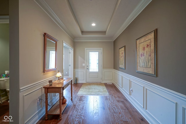 16209 Natures Way, Westfield, IN 46074 - entrance foyer featuring a decorative wall, dark wood-type flooring, a wainscoted wall, a raised ceiling, and crown molding