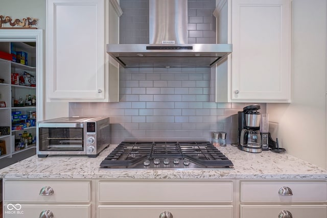 16209 Natures Way, Westfield, IN 46074 - kitchen featuring wall chimney range hood, stainless steel gas cooktop, backsplash, and white cabinetry