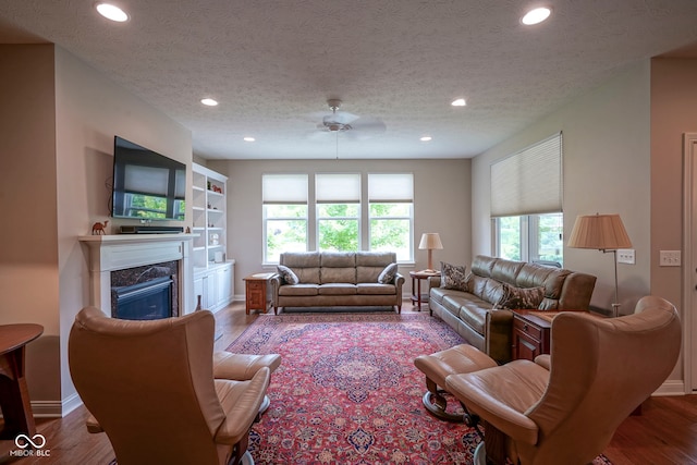 16209 Natures Way, Westfield, IN 46074 - living room featuring recessed lighting, a fireplace, a textured ceiling, and wood finished floors