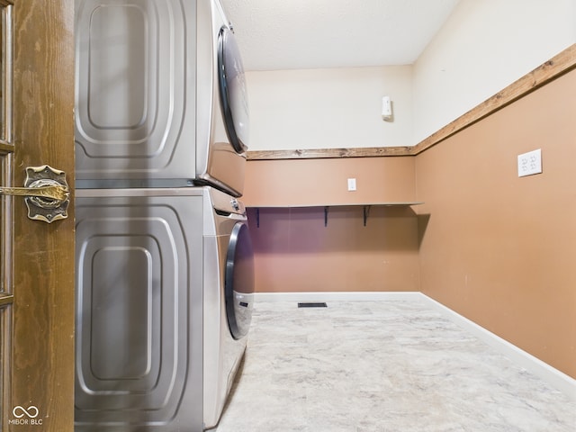 114 Bluebird Ln, Sulphur Springs, IN 47388 - washroom featuring stacked washing machine and dryer and baseboards