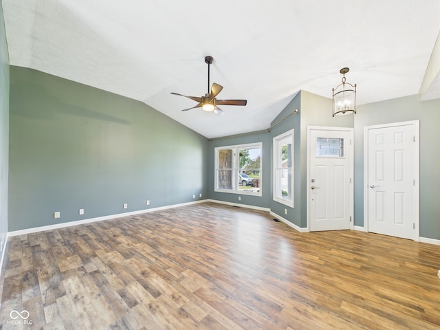 114 Bluebird Ln, Sulphur Springs, IN 47388 - unfurnished room with wood finished floors, a ceiling fan, baseboards, lofted ceiling, and a chandelier