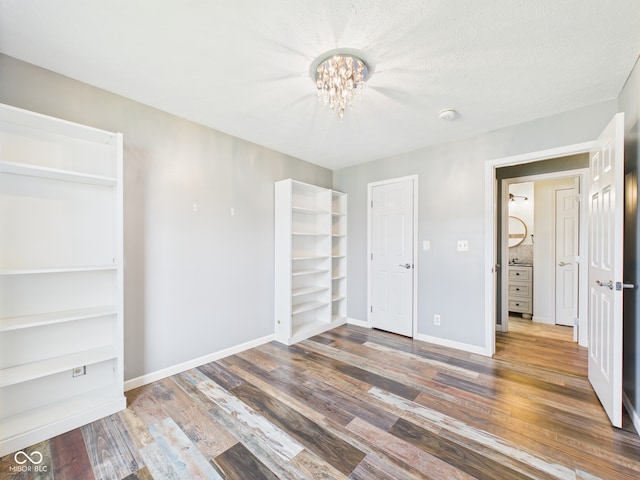 114 Bluebird Ln, Sulphur Springs, IN 47388 - unfurnished bedroom featuring a chandelier, wood finished floors, and baseboards