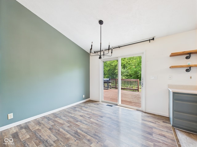 114 Bluebird Ln, Sulphur Springs, IN 47388 - unfurnished dining area featuring a chandelier, wood finished floors, and vaulted ceiling