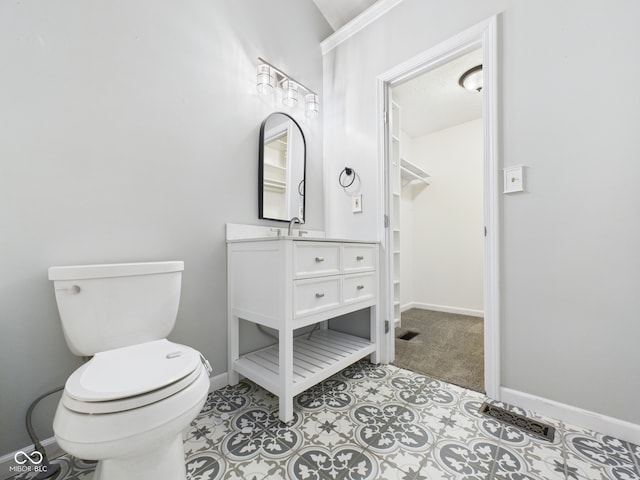 114 Bluebird Ln, Sulphur Springs, IN 47388 - bathroom with vanity, baseboards, toilet, and a spacious closet