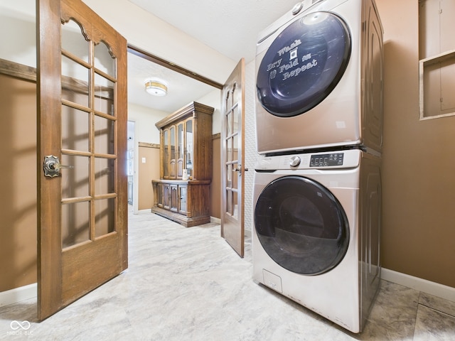 114 Bluebird Ln, Sulphur Springs, IN 47388 - laundry area with stacked washing machine and dryer, french doors, and baseboards