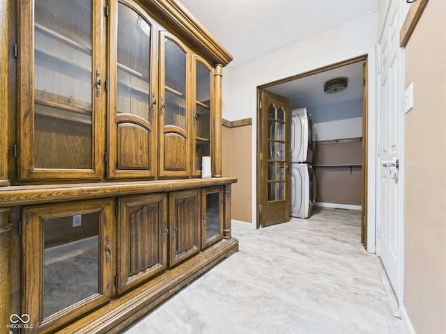 114 Bluebird Ln, Sulphur Springs, IN 47388 - hallway featuring stacked washer / dryer and baseboards