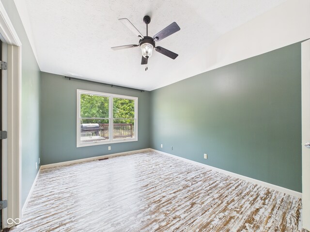 114 Bluebird Ln, Sulphur Springs, IN 47388 - unfurnished room with ceiling fan, wood finished floors, and vaulted ceiling