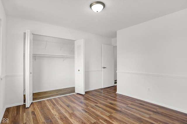 2642 Country Estates Dr, Indianapolis, IN 46227 - unfurnished bedroom featuring a closet, wood finished floors, and baseboards