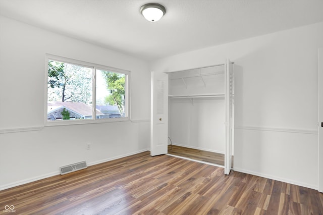 2642 Country Estates Dr, Indianapolis, IN 46227 - unfurnished bedroom with wood finished floors, a closet, and baseboards