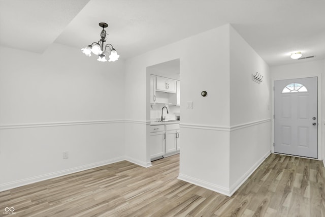 2642 Country Estates Dr, Indianapolis, IN 46227 - entrance foyer featuring light wood-type flooring, a chandelier, and baseboards