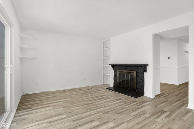 2642 Country Estates Dr, Indianapolis, IN 46227 - unfurnished living room featuring wood finished floors, a fireplace, built in features, and baseboards