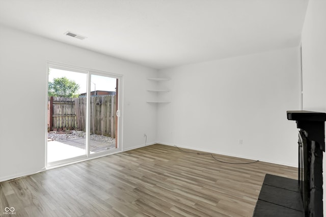 2642 Country Estates Dr, Indianapolis, IN 46227 - unfurnished living room with light wood-type flooring and baseboards