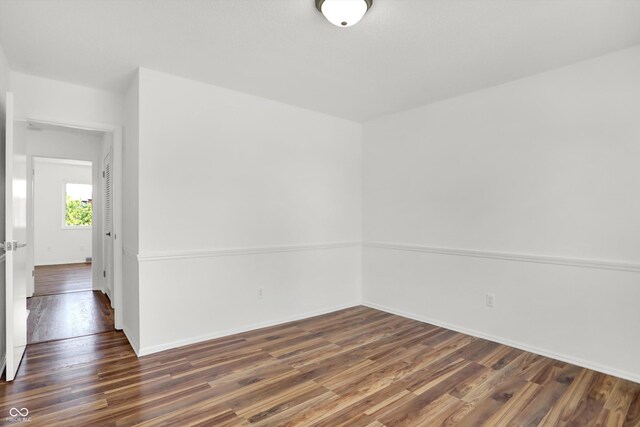 2642 Country Estates Dr, Indianapolis, IN 46227 - spare room featuring dark wood-style flooring and baseboards