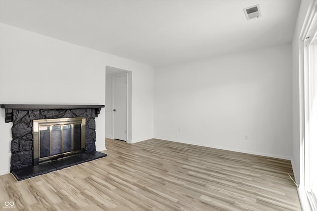 2642 Country Estates Dr, Indianapolis, IN 46227 - unfurnished living room featuring a fireplace, light wood-style flooring, and baseboards