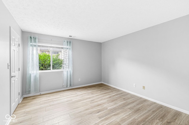 1044 Timber Creek Dr Unit 2, Carmel, IN 46032 - spare room featuring light wood-style floors and a textured ceiling