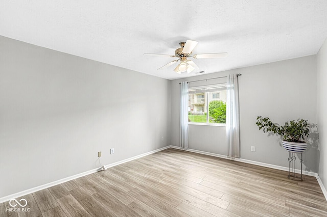 1044 Timber Creek Dr Unit 2, Carmel, IN 46032 - spare room with wood finished floors, ceiling fan, and a textured ceiling
