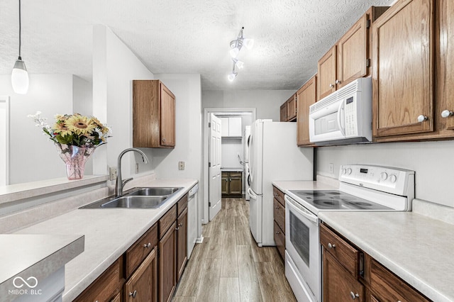 1044 Timber Creek Dr Unit 2, Carmel, IN 46032 - kitchen with white appliances, light wood-type flooring, a textured ceiling, light countertops, and decorative light fixtures